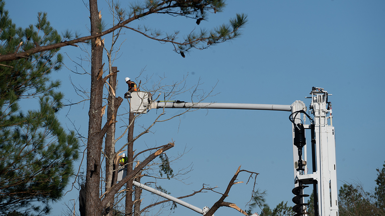 Crews work to restore power in Tylertown, Mississippi, on Sunday, following severe weather that moved through the service area on Saturday.